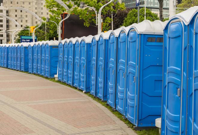 a row of portable restrooms set up for a large athletic event, allowing participants and spectators to easily take care of their needs in Harrison NY